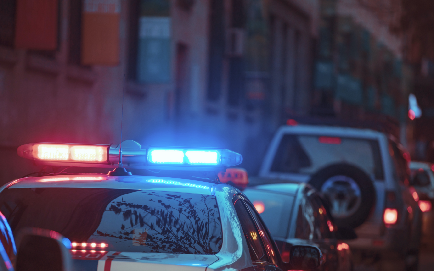 A police car with red and blue lights flashing