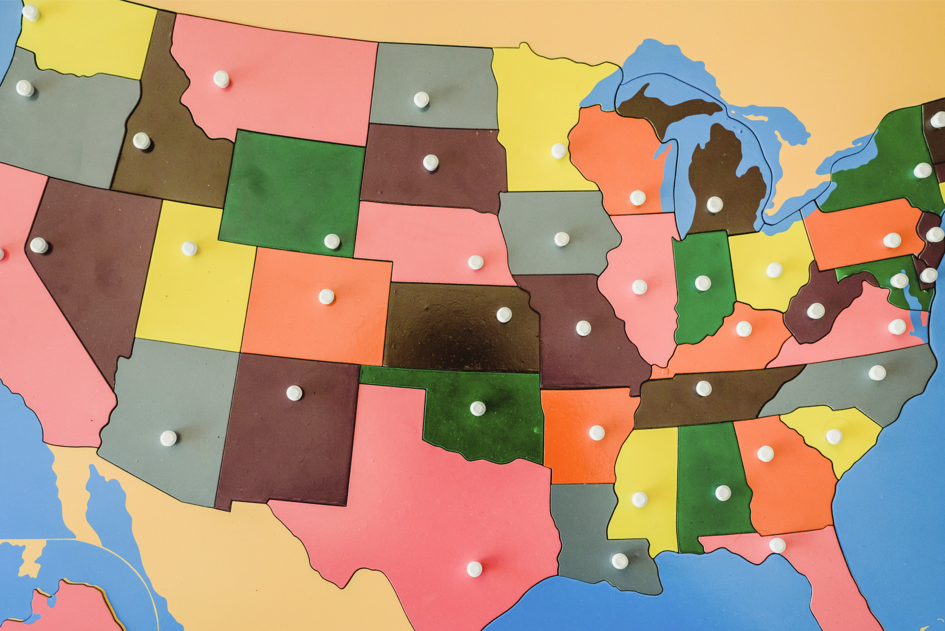 A wooden puzzle map of the United States.